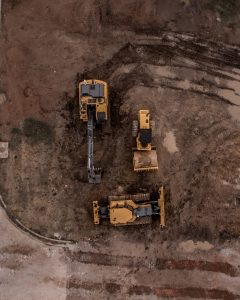 Aerial photo of excavator road roller and bulldozer